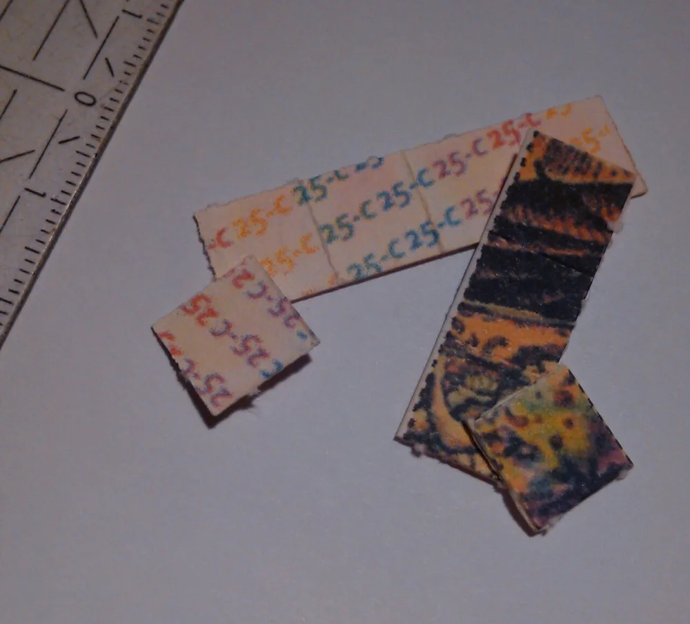 Perforated blotter squares of 25C-NBOMe shown against a ruler, each carrying about 1200 µg; some are printed with the compound name, others with decorative art. NBOMe blotters look exactly like LSD blotter.