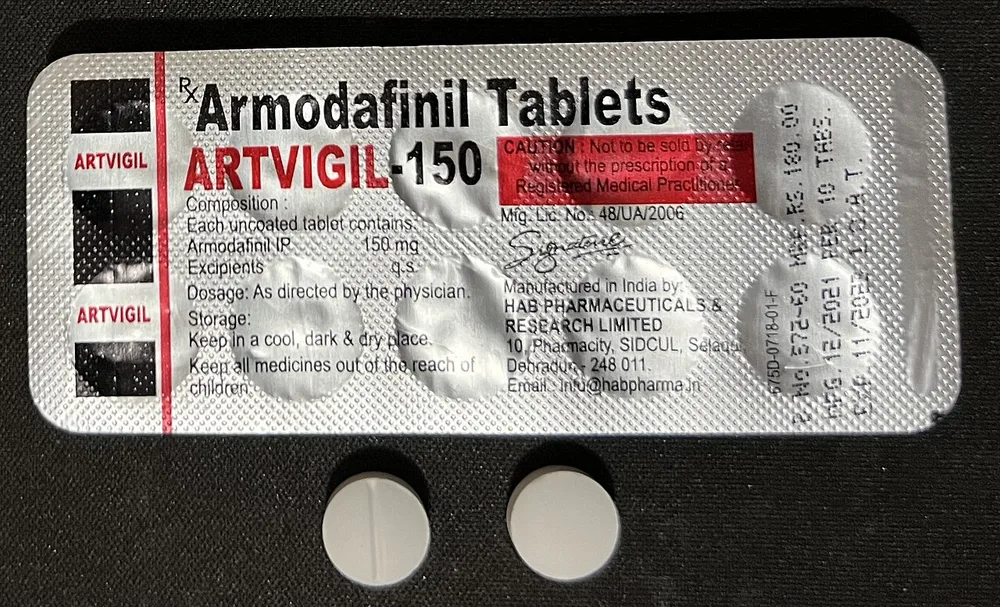 Armodafinil 150 mg: foil blister strip of Artvigil-150 (HAB Pharmaceuticals, India) with two round white scored tablets. Indian generic blisters like this are the commonest presentation encountered.