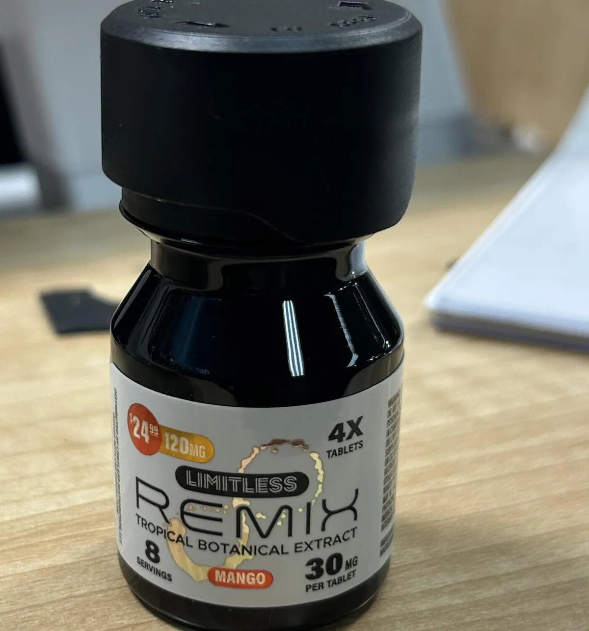 A small black bottle with a white label: 24.99 dollars, 120 MG, 4X tablets, LIMITLESS REMIX, Tropical Botanical Extract, Mango, 8 servings, 30 mg per tablet.