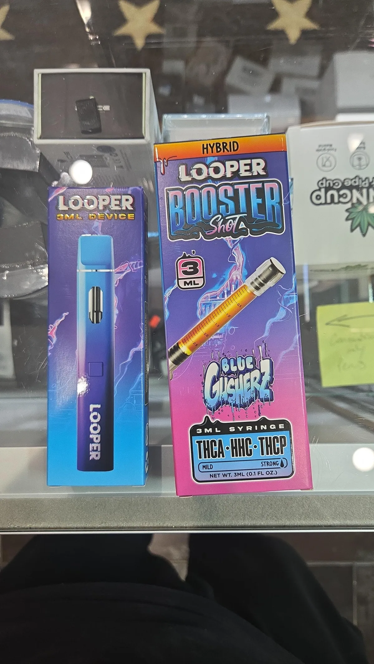 Two Looper boxes on a shop counter in January 2026: a Looper 3ml device, and a Looper Booster Shot, Blue Gusherz, 3ml syringe, THCA, HHC, THCP.