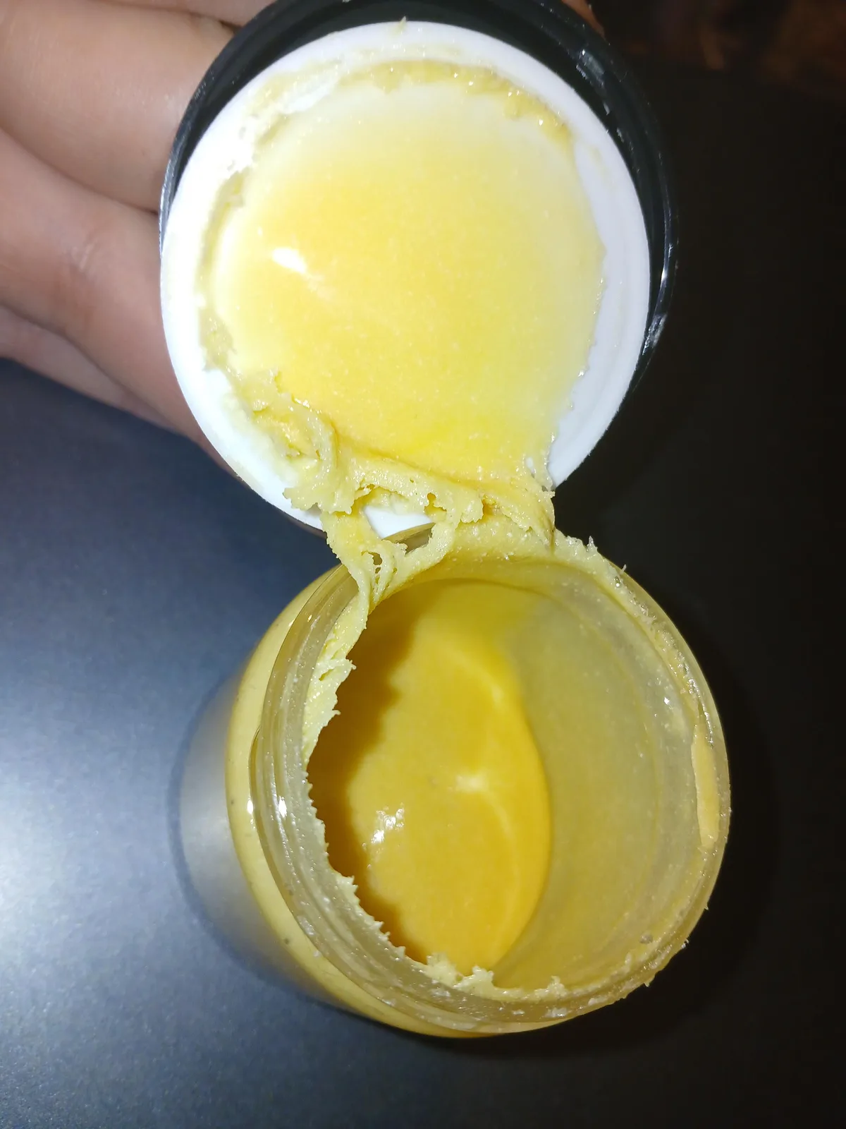 A buyer's photo of an open plastic jar and its lid, both coated in a thick, pale yellow paste, posted to r/CultoftheFranklin in December 2025 as Vivimu live rosin.