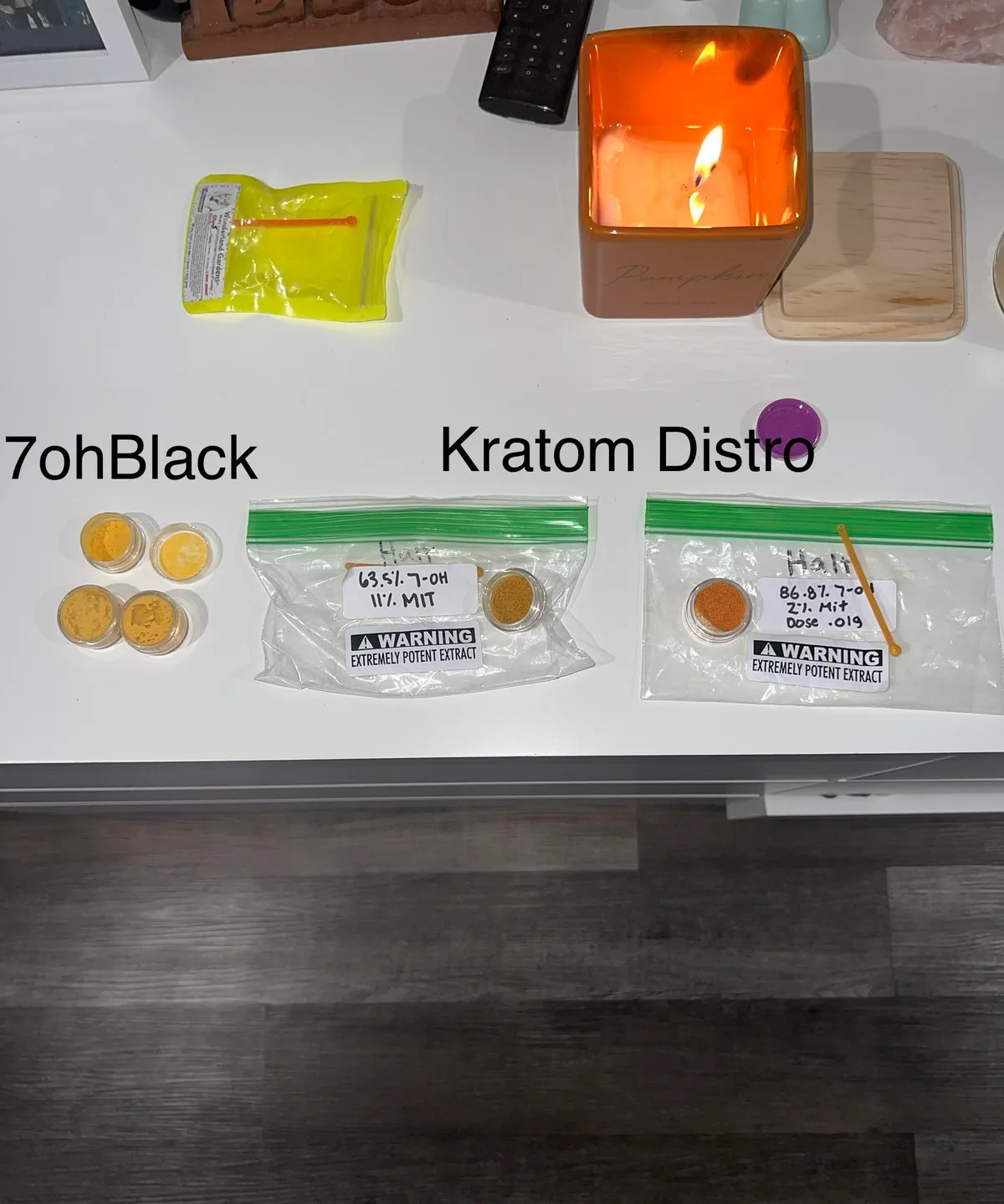 Jars of orange powder labelled 7ohBlack on the left and two zip bags labelled Kratom Distro on the right, one hand-marked 63.5% 7-OH 11% MIT and the other 86.8% 7-OH 2.1% MIT, each with an Extremely Potent Extract warning sticker.