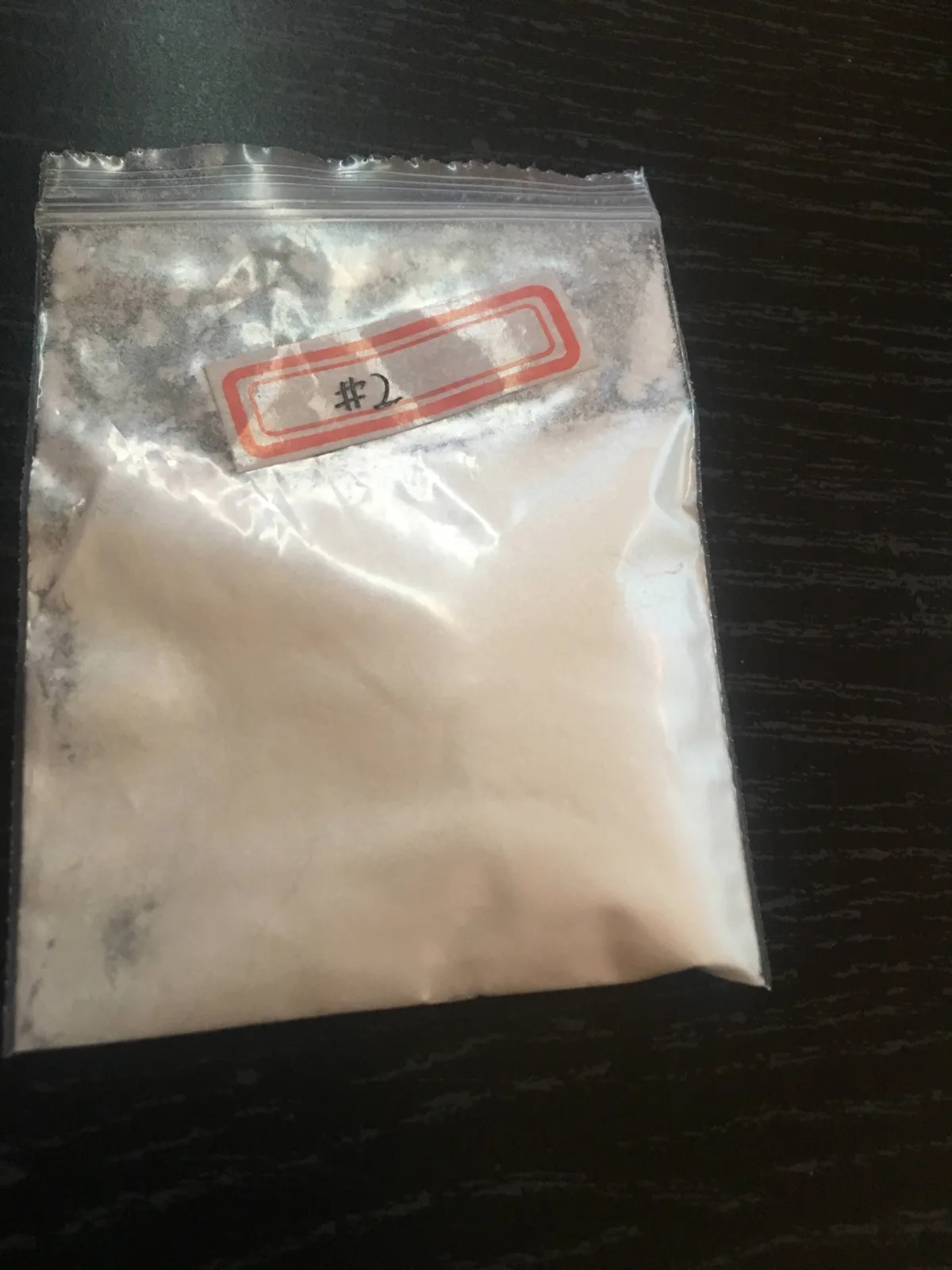 A buyer's photograph from January 2018: a zip bag of white powder with a small red-bordered sticker on which #2 is handwritten.
